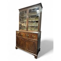 George III mahogany bookcase secretaire, dentil cornice over blind fret work frieze, enclosed by two astragal glazed doors, central secretaire drawer with fall front enclosing leather writing surface and small drawers, two flanking short drawers over double cupboard, on bracket feet