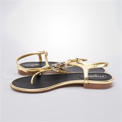 Chanel - pair of gold leather thong sandals, from the 2021 Summer Collection, the uppers centred with an interlocking gold tone CC motif in chain and leather, size 37C, unused with original dust bags
