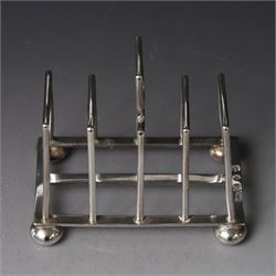 Victorian silver toast rack, with five angular bars and loop handle, upon four squat bun feet, hallmarked Thomas Hayes, Birmingham 1893, height including handle H10cm