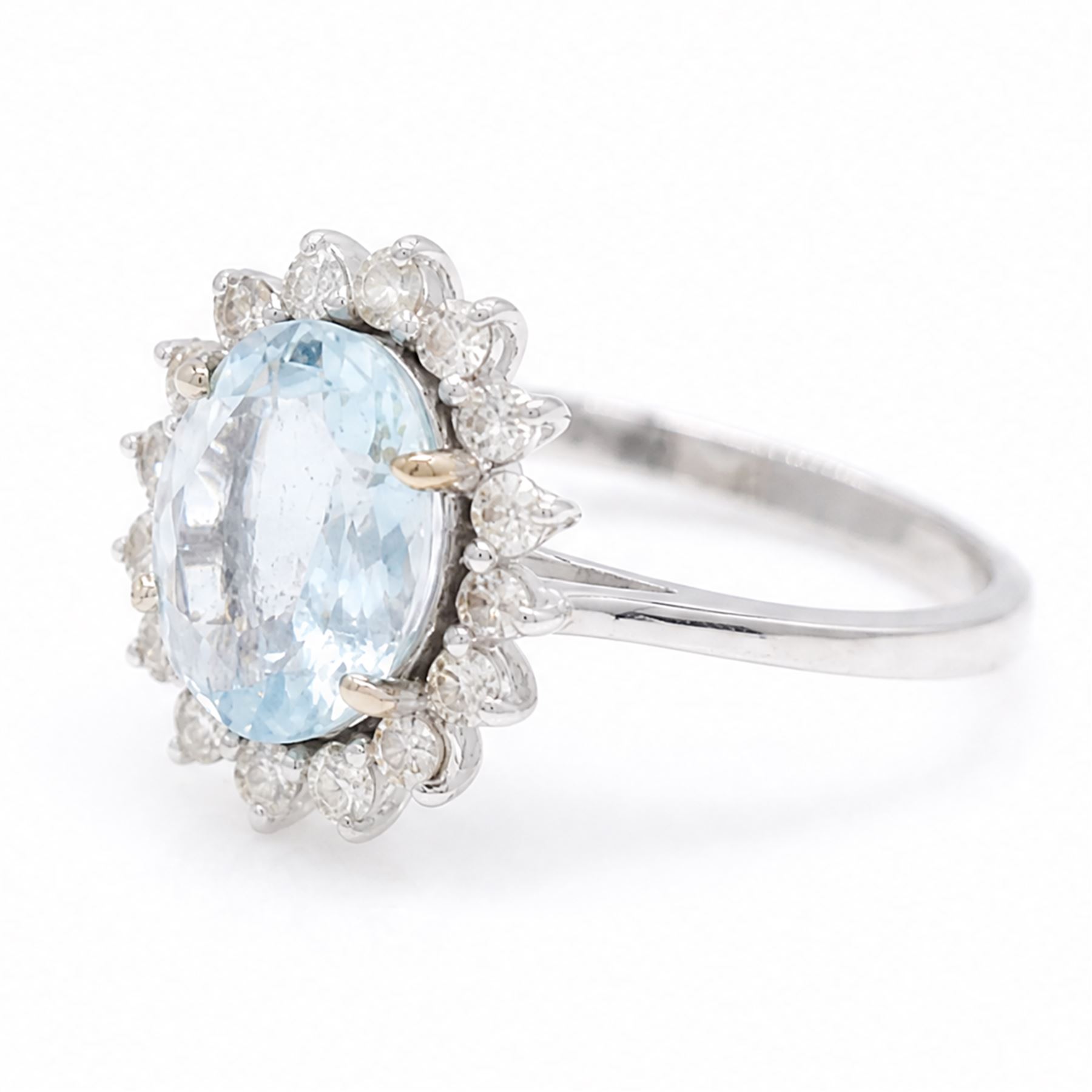 18ct white gold aquamarine and diamond cluster ring, single oval cut aquamarine of approx 2.05 carat, surrounded by sixteen round brilliant cut diamonds, stamped 18K, total diamond weight approx 0.50 carat
