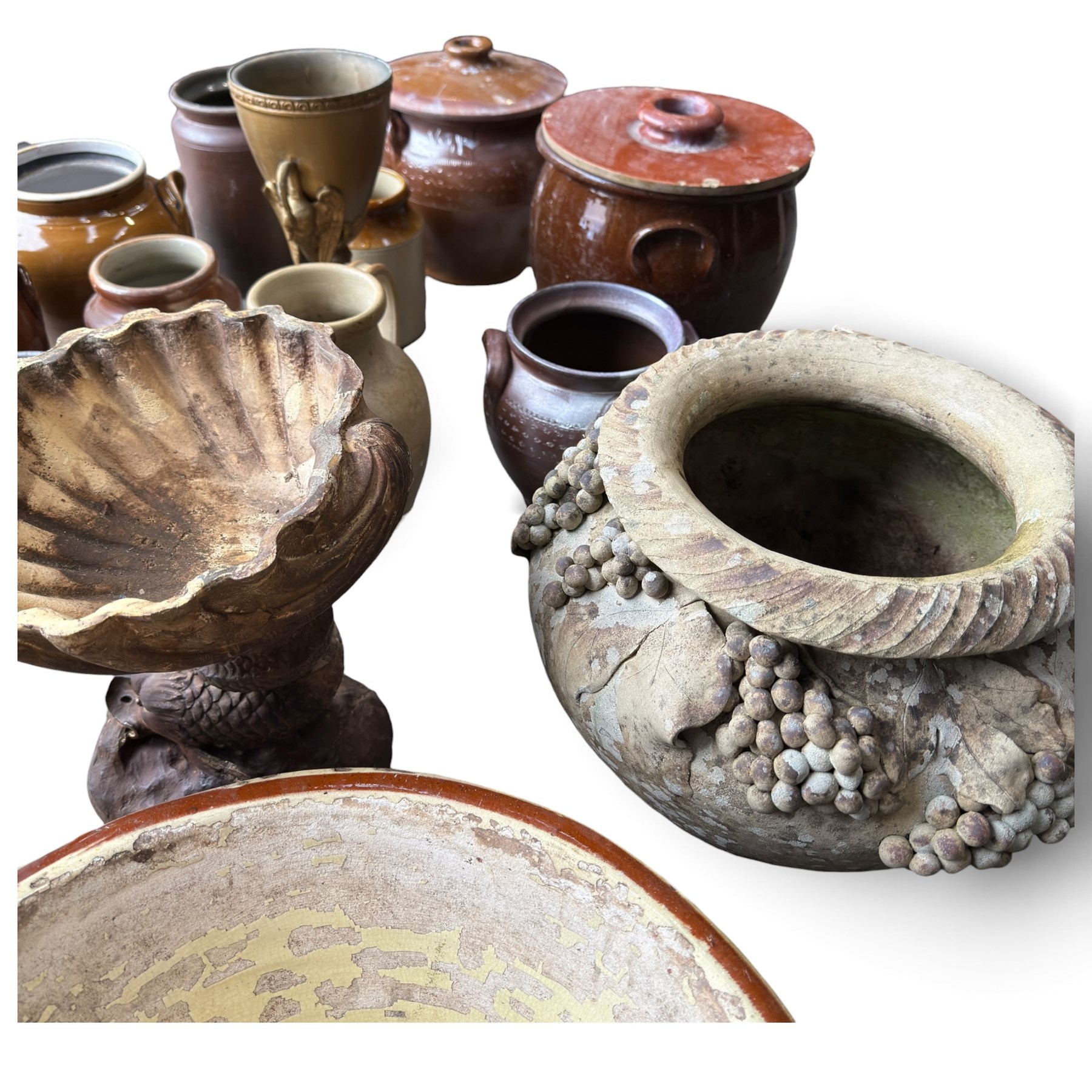 Large assorted collection of glazed stoneware jars and planters, with two lidded crocks, a brass urn and three decorative garden planters, including a pair of shell-form examples