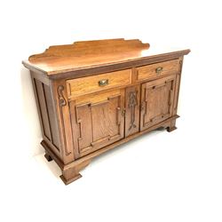 Edwardian oak sideboard, raised and shaped back, two short drawers above two cupboard doors enclosing fitted interior, shaped bracket supports