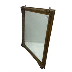 19th century gilt framed wall mirror, the corners decorated with flower heads with extending foliage, plain mirror plate