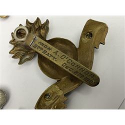 Fourteen cap badges of Irish interest including Royal Dublin Fusiliers inscribed to the slider 'From A. O'Connor 2nd Batt. Dec.2nd 1915', Connaught Rangers, South irish Horse Yeomanry, Inniskilling Fusiliers, Royal Irish Regiment etc; and seven Welsh badges including South Wales Borderers, Welsh Guards, 3rd Bn. Monmouthshire Regt. etc (21)