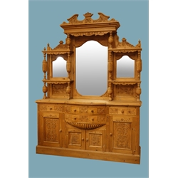  Large Victorian style waxed pine mirror back sideboard, carved pediment, stepped projecting cornice above three mirrors, turned and acanthus carved baluster supports, break bow front above four drawers and cupboards with relief carved panelled doors, plinth base, W182cm, H250cm, D49cm  