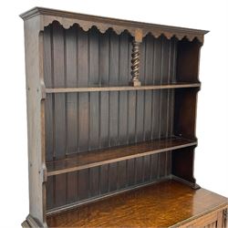 Early to mid-20th century oak dresser, raised two tier plate tack over two linenfold panelled doors, on spiral turned supports united by undertier 