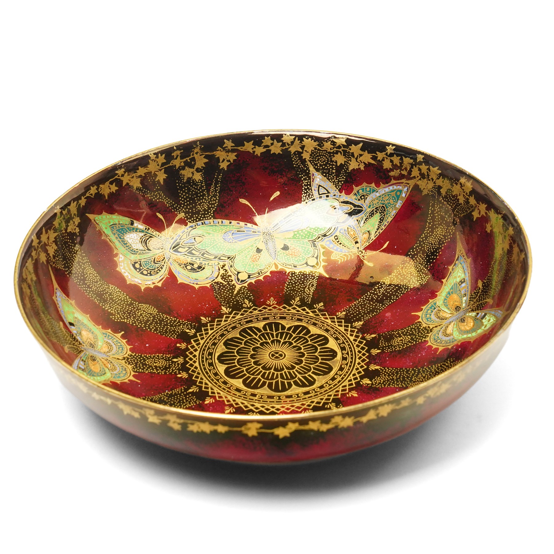 Four pieces of Fielding's Devon Lustrine, comprising a small pair of sleeve vases, H15cm; a bowl and vase, each decorated with butterflies and leaves in gilt on a red ground, printed marks beneath (4)