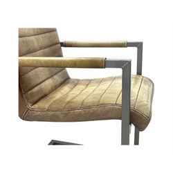 Pair of contemporary industrial style armchairs, each featuring a squared steel cantilever frame with upholstered arms, the seat and back finished in channel-stitched distressed tan faux leather