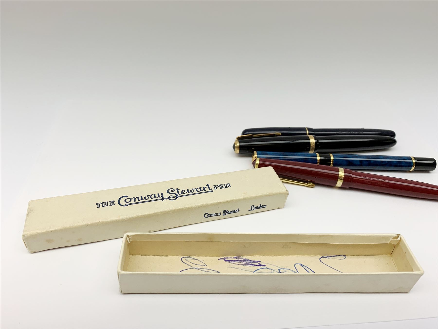 A group of four fountain pens, comprising Parker Duofold, nib marked 14K, Swan Mabbie Todd & Co Ltd Self Filler, nib marked 14C 585, Conway 57, nib marked 14ct, and Waterman Laureat. 