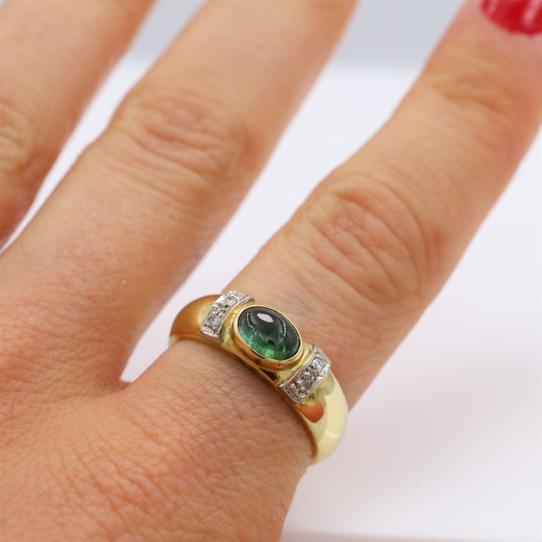 18ct gold tourmaline and diamond ring, bezel set single oval cut tourmaline, with two single cut diamonds set either side, stamped 