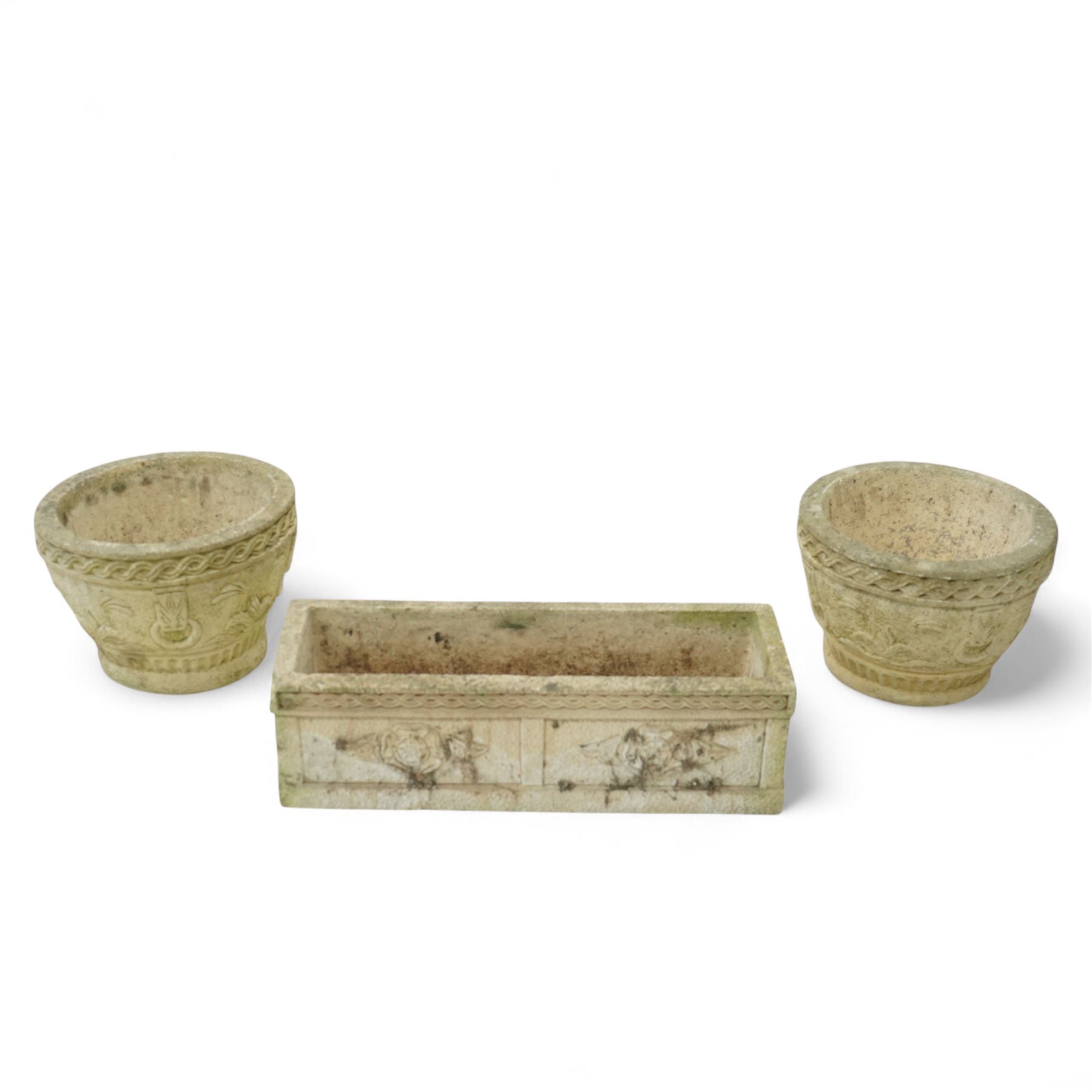 Cotswold Studios - set of three cast stone garden planters, comprising a rectangular trough with rose decoration (H 18cm, D 21cm, W 61cm) and two round pots with stylised floral and ropework borders (H 24cm, D 34cm)