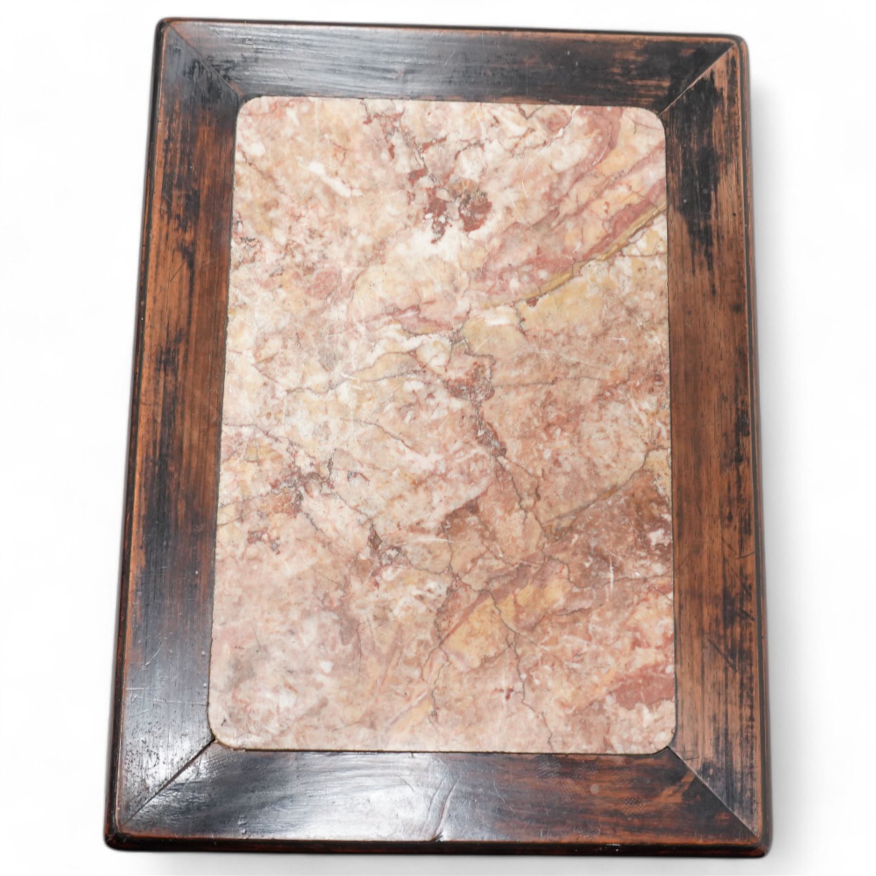 Early 20th century Chinese carved hardwood and marble urn stand, rectangular moulded top with inset variegated rouge marble, carved with curling leafy branches and scrolls, shaped and pierced brackets, on ball and claw carved supports 