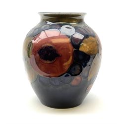 Moorcroft vase of baluster form, decorated in Pomegranate and Berries pattern upon a dark blue ground, with impressed marks beneath, H10.5cm.