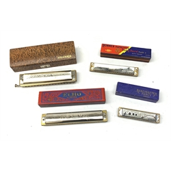 A group of four cased Harmonicas, comprising a Hohner 64 Chromonica, a Hohner Echo, a Hohner Song Band, and a Band Master Fancy. 