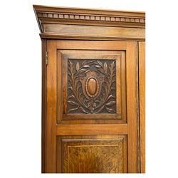 Late Victorian walnut triple combination wardrobe, projecting moulded and dentil cornice, central shaped bevelled mirror glazed door, cartouche and curled leaf carved panels over figured walnut veneered panels, fitted with drawer to base, on bracket feet