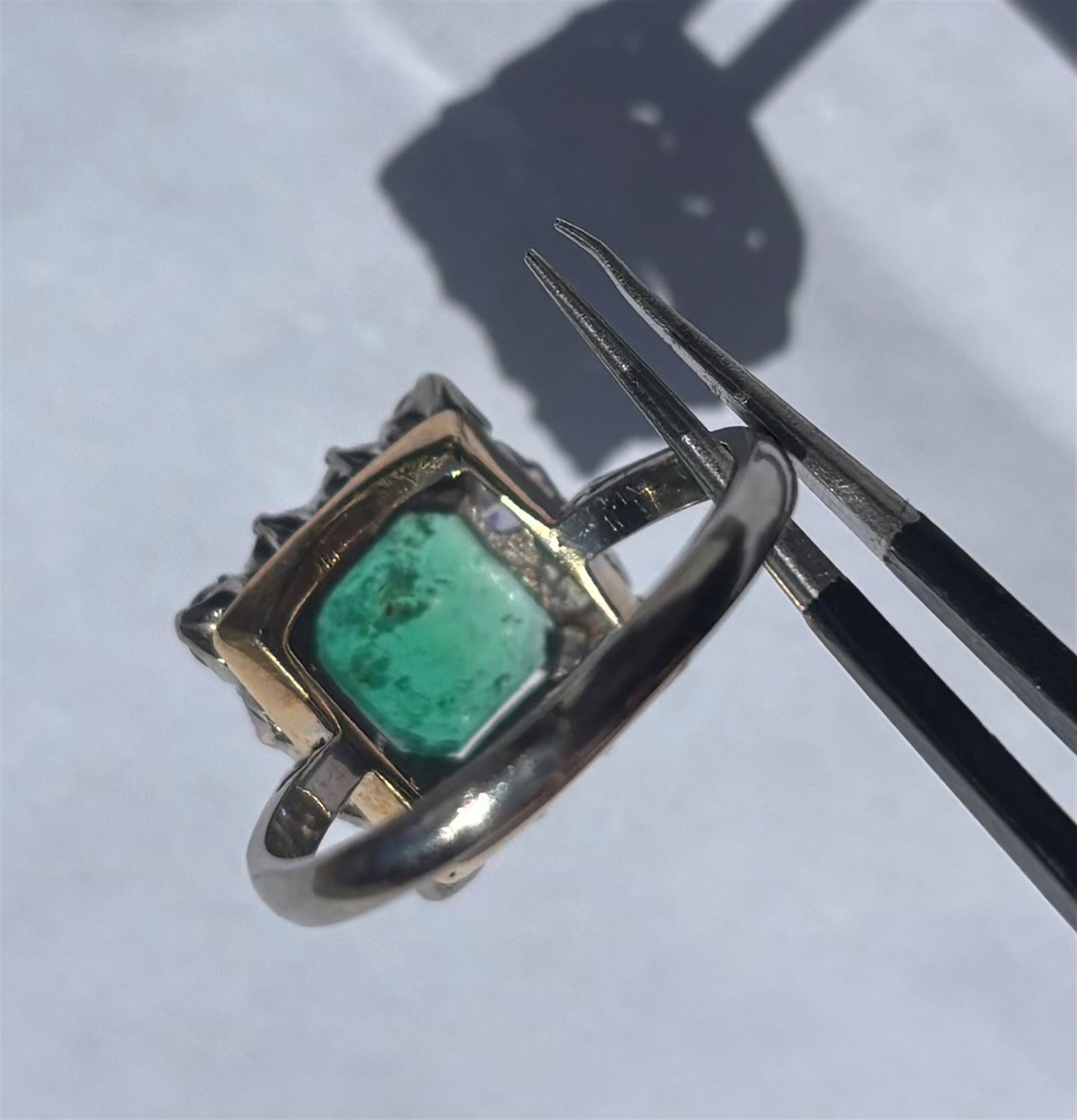 18ct white and yellow gold emerald and diamond cluster ring, single octagonal cut emerald of approx 1.55 carat, surrounded by twelve round brilliant cut diamonds, total diamond weight approx 0.95 carat