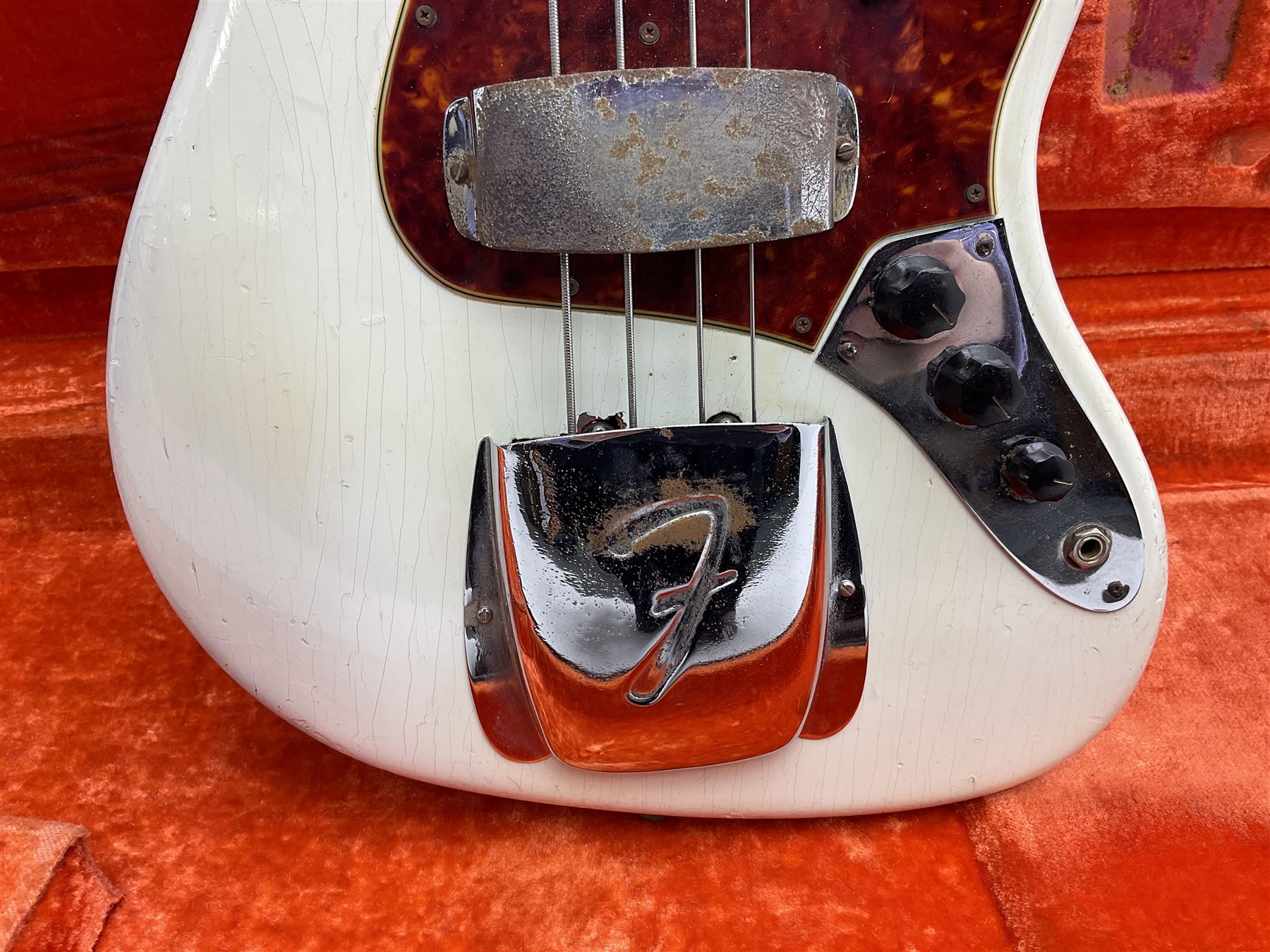 1963 Fender Jazz three-knob bass guitar; impressed with date code 7AUG63A on end of neck and serial no.L08587 on back plate; all original but re-finished in white in the 1970s; sold with photographs of the instrument in the 1960s with original finish and in the 1970s re-finished; L117.5cm; in original hard carrying case; Provenance: the professional guitar of Howard Livett from new to his death in 2005. Howard played in The Humperdincks, the backing group for Englebert Humperdinck, also played in the backing group for Max Bygraves and in the band Hedgehoppers Anonymous. The guitar is also sold with a manuscript letter of provenance from Howard's wife.