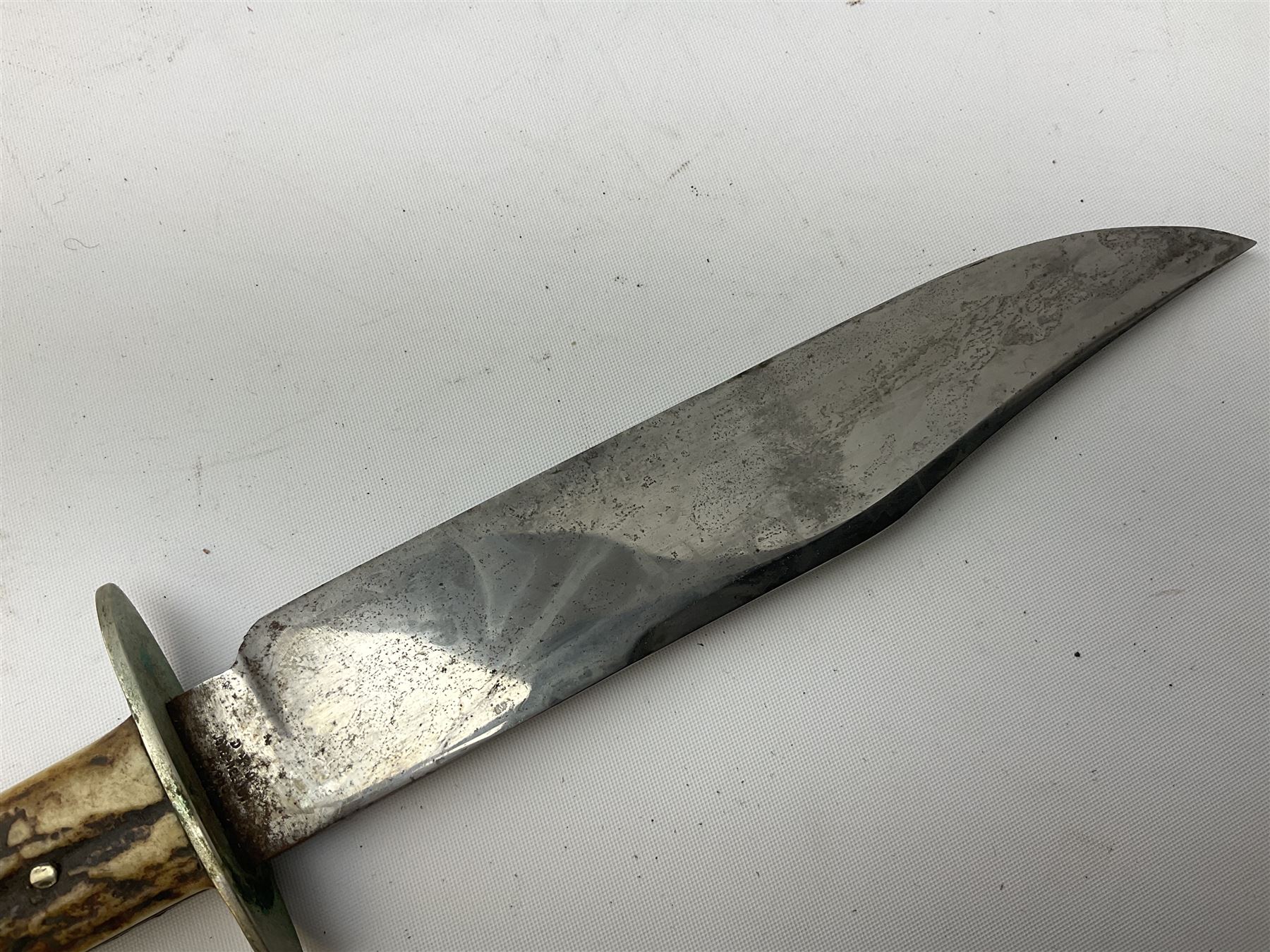 Hunting knife by J Nowill & Sons, Sheffield, the handle inset with mother of pearl, blade length 19cm; George Wolstenholme IXL lock-knife with antler scales L29cm open; and another Bowie style hunting knife marked 'V.R. Warranted Sheffield Joseph Ellis & Sons' in leather sheath (3)