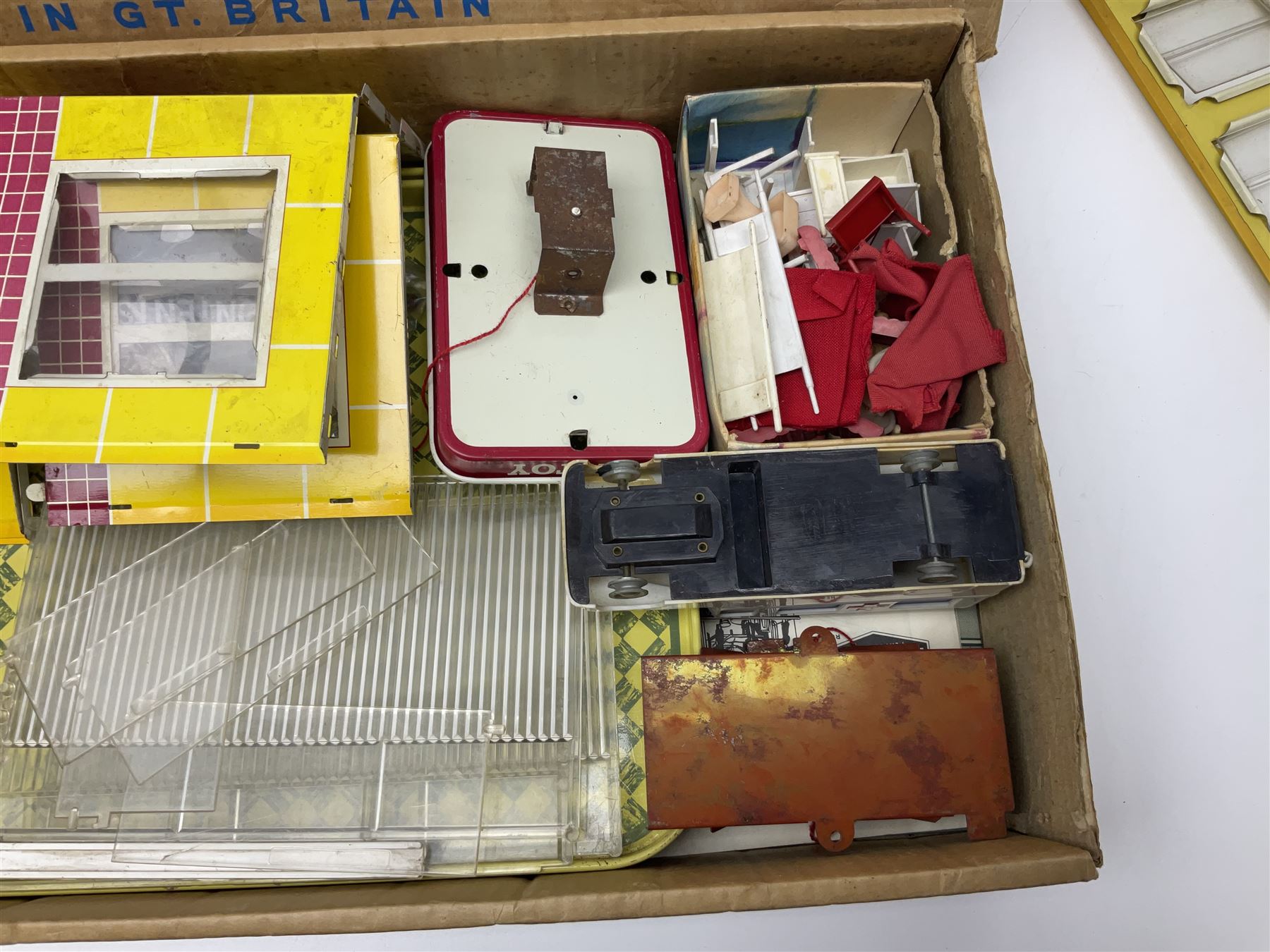 Late 1950s/early 1960s Mettoy tin-plate Emergency Ward 10 hospital set from the TV series, including over twenty figures, over sixty pieces of hospital equipment, beds, chairs, lockers, theatre fittings, stretchers etc; building is complete with movable transparent partitions, operating lift with sliding lift shaft doors and opening windows; wards with fitted swing doors; tin-plate walls with lithographed detail in yellow with red and white tiled effect, cobbled base with ambulance casualties area and lift access; boxed with instructions