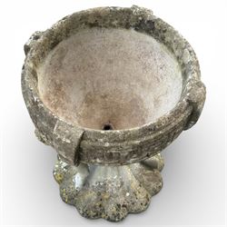 Cast stone urn with two figures supporting the bowl