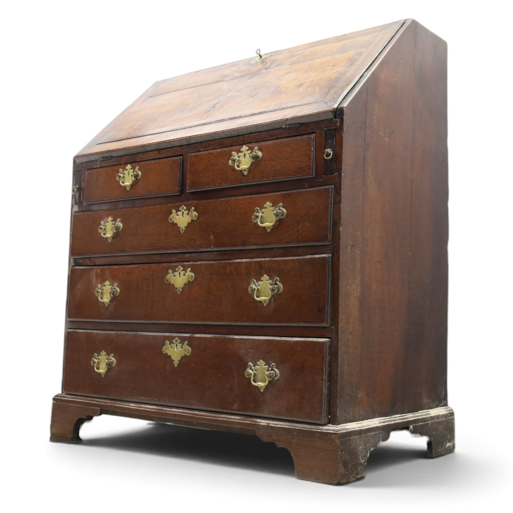 18th century inlaid oak bureau, the fall-front with central star inlay enclosing fitted interior with central cupboard flanked by fluted column correspondence drawers and pigeon holes, over two short and three long drawers, lower moulded edge on bracket feet