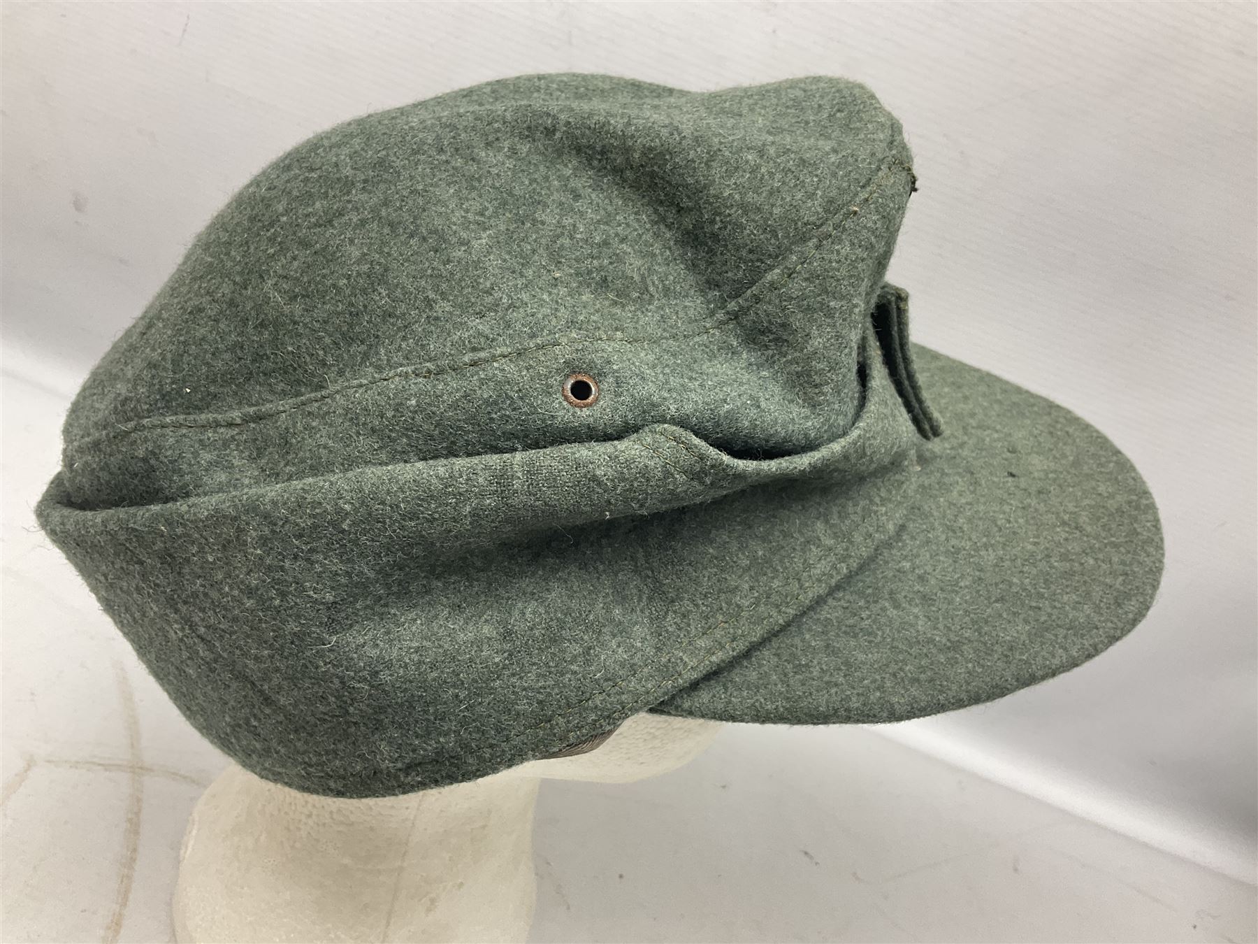 WW2 German Army M43 field cap with triangular cloth eagle and roundel badge and metal edelweiss badge for mountain troops; faintly stamped '5 VMF(?)'