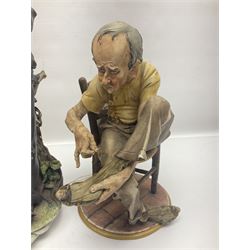 Three Capodimonte figures, to include The Kind Heart Man, modelled by Cortese as a tramp with two doves, The Young Falconer by Maria Angela and another modelled as a tramp darning his socks, all with printed marks, tallest H39cm