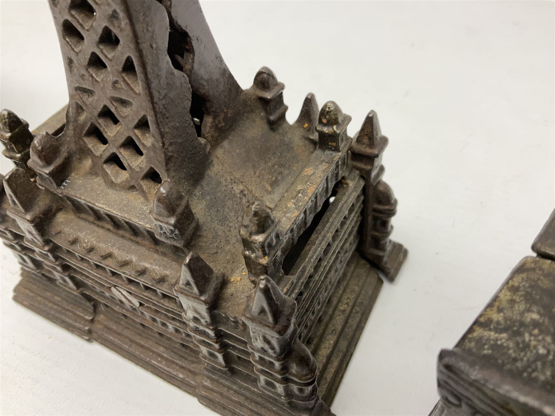 Five early 20th century cast-iron money banks as buildings - 'City Bank' c1904 H10cm; 'County Bank' c1905 H11cm; 'Town Hall Bank' c1900 H8.5cm; 'Tower Bank' c1902 H23.5cm; all made by John Harper; and 'Blackpool Tower Bank' c1907 by Chamberlain & Hill H18.5cm (5)