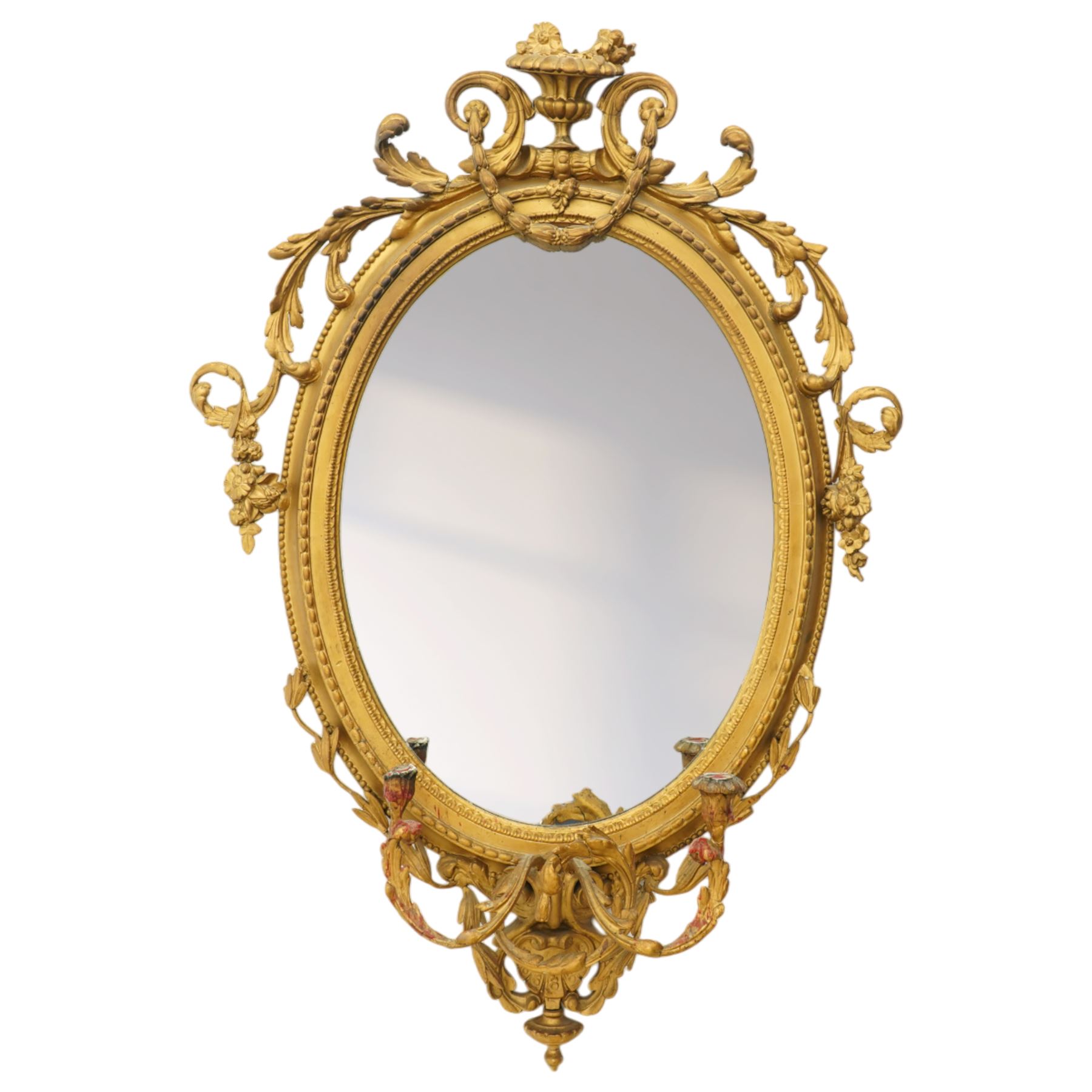 Late 19th century Louis XVI style giltwood and gesso girandole oval wall mirror, the oval frame surmounted with stylized urn finial and ribbon-tied garlands, laurel swags and rosettes, egg and dart decorated inner moulding and linked acorn outer moulding, flanked by intertwined foliate decorated candle branches 