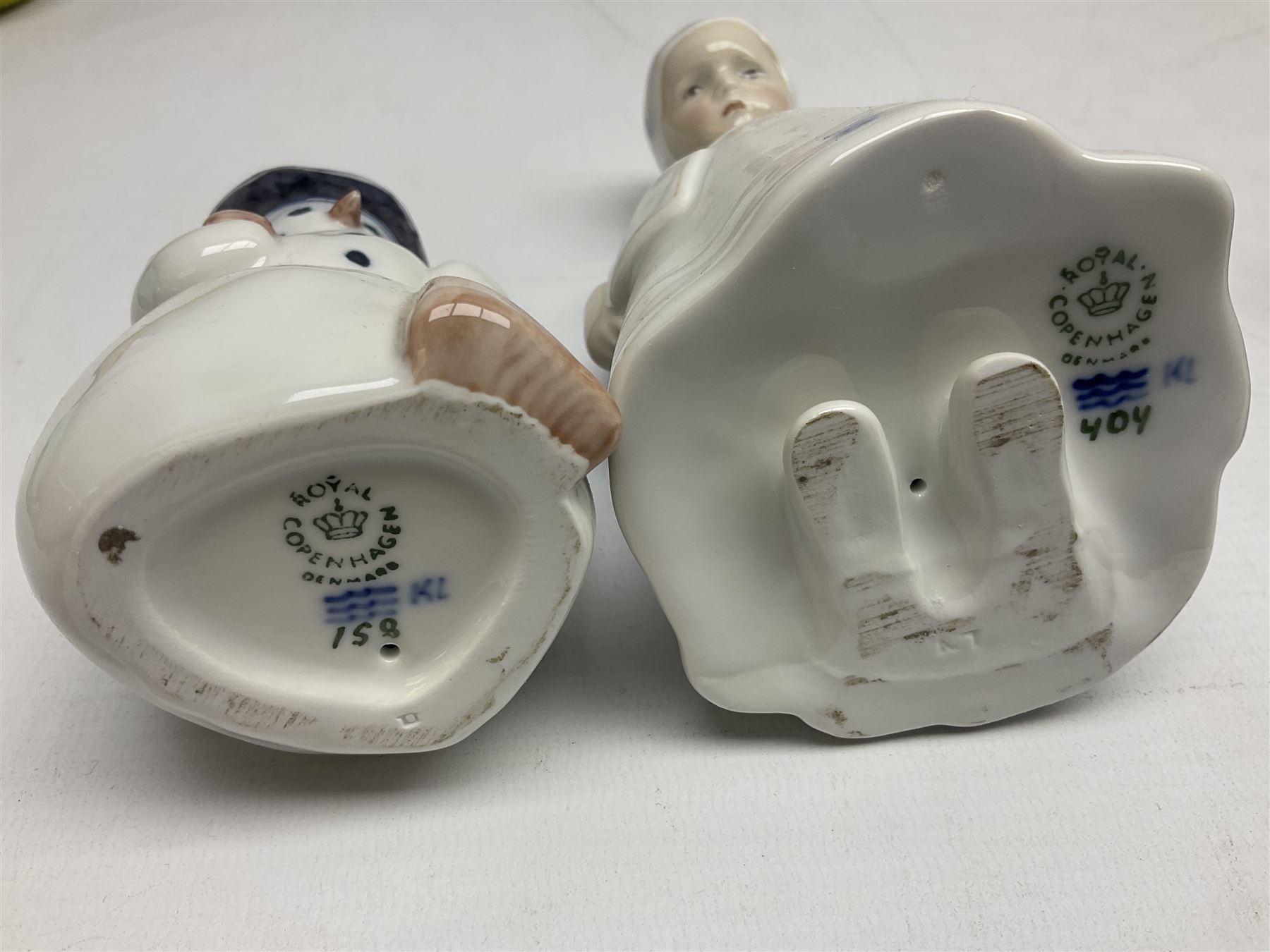 Four Royal Copenhagen figures, comprising Else with teddy no. 671, Snowman no. 158, Elsa no. 404, an mini collection girl with pram no.014, all with mark beneath  