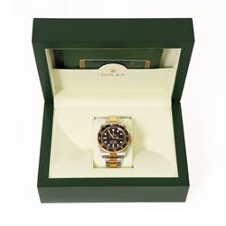 Rolex Oyster Perpetual Submariner Date gentleman's stainless steel and gold automatic wristwatch, Ref. 116613LN, serial No. 8201P7C5, back dial with luminous hour markers, unidirectional rotating black ceramic bezel, on stainless steel and yellow gold Rolex Oyster bracelet with fold-over clasp, boxed with guarantee card dated 2013