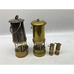 Two brass miners lamps to include an Eccles Manchester Type 6 example, together with two miniature brass lamps stamped Bickershaw Colliery