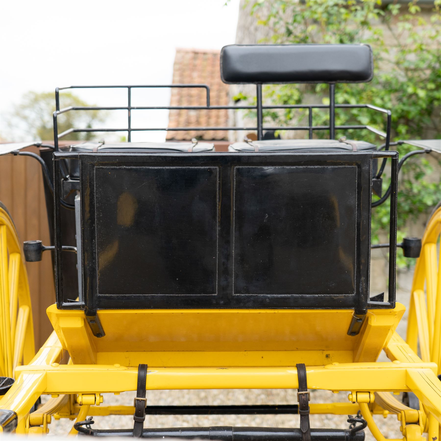 J. W. Thompson Dog Cart

A black and yellow painted two wheeled dog cart with elevated upholstered seat for two, buttoned black leather cushions, high back rail, folding front footboard, louvred sides, side steps, rear drop-down tailboard with chain stays, internal storage compartment, wooden spoked wheels, rubber tyres and shafts for a single horse. The wheel hubs are marked J W Thompson

Dimensions:
Overall length: 366 cm
Width: 160 cm
Height: 190 cm

Wheel Diameter:
Wheels: 139 cm

Seating:
Driver and passenger: 2