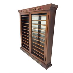 Modern hardwood display cabinet for model railway locomotives inscribed 'Gresley Pacifics' to the frieze and 'LNER' to the bottom rail; with mirrored back and ten loose fitting shelves enclosed by a pair of unglazed doors L101cm H108cm D16cm