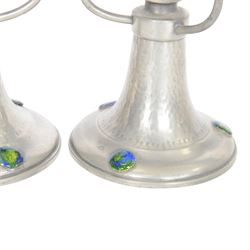 Pair of  Jugendstil hammered pewter candlestick each set with three blue and green enamel roundels, marked Germany beneath, H12cm
