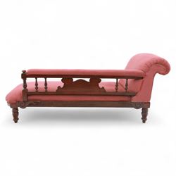 Late Victorian mahogany chaise longue, of scroll-ended form, upholstered in red diamond-patterned fabric with padded back and scroll-carved support, open arm with carved foliate and turned upright, raised on turned tapering legs 