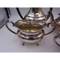 1920s silver four piece silver tea service, comprising coffee pot, teapot, milk jug and twin handled open sucrier, all a oval bellied form, with faceted body, and upon four pad feet, the coffee pot and teapot with ebonised handles and finials, hallmarked A & J Zimmerman Ltd, Birmingham 1925 & 1928