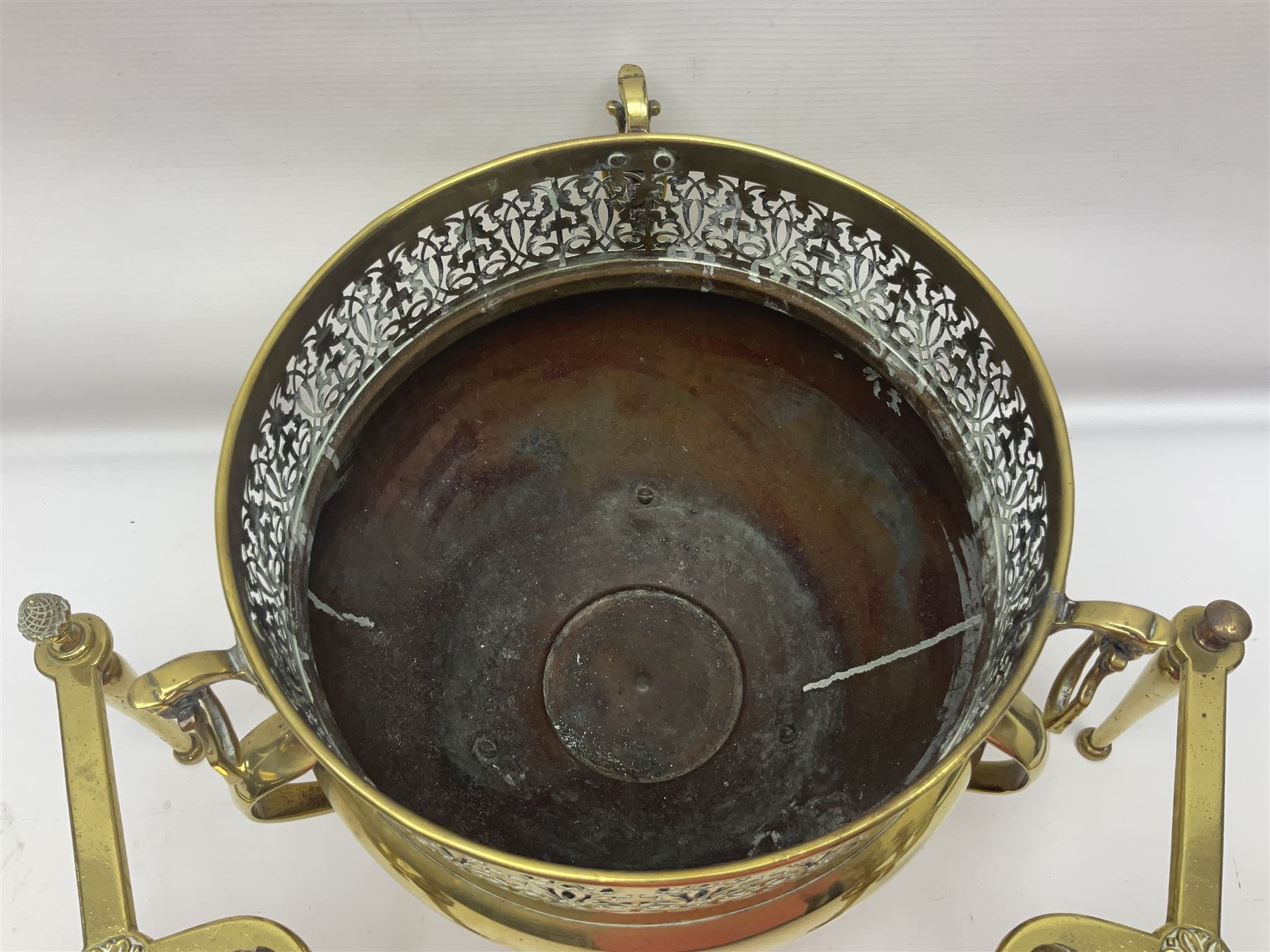 Early 20th century brass coal bucket with pierced sides, upon three pad feet, together with a pair of brass fire dogs, with flambe finials, coal bucket H27cm