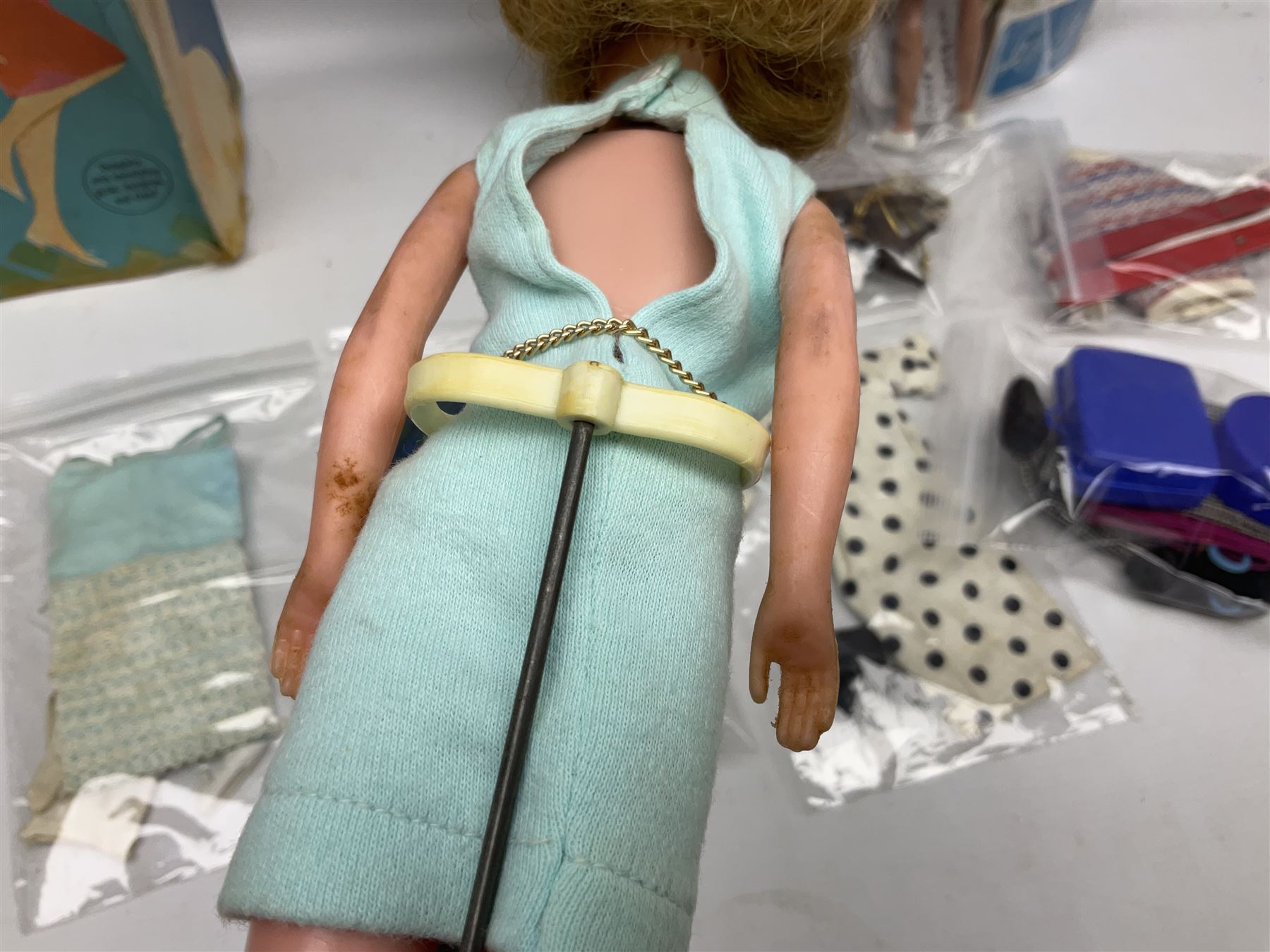 1960s Palitoy Tressy fashion doll, boxed with stand and booklets; four additional Tressy outfits (In The Office, Winter Journey, Winter Sports and Evening Date); two other outfits; and Tressy's Little Sister Toots doll with Style Book and additional outfit