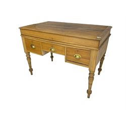 Early 20th century light oak kneehole desk, rectangular hinged top, fitted with frieze drawer flanked by two deep drawers, raised on ring turned supports