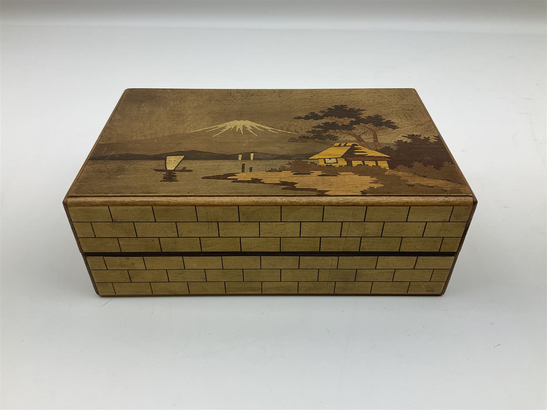 Japanese parquetry puzzle box L12cm; another Japanese puzzle box with marquetry top of Mount Fuji; eleven graduated Chinese figures including immortals; and Chinese figure of a lady standing on a hardwood base next to a horn table (14)