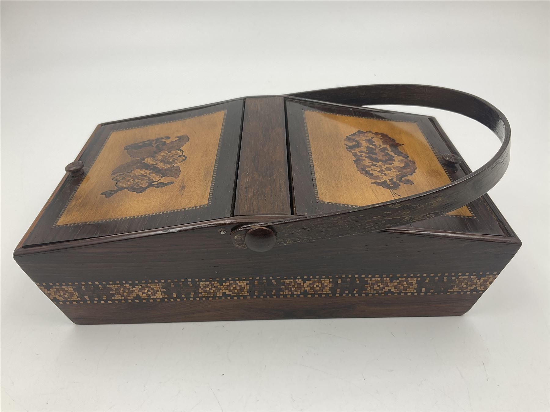 19th century rosewood Tunbridge Ware basket, of rectangular form with curved bentwood handle, and twin hinged sloping covers, lifting to reveal paper lined interiors, not including handle H5.5cm D10.5cm L18cm