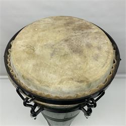 Native conga drum, with green painted coopered wooden body, pig skin head and metal tensioners; bears printed paper label 'Carakaitu Tumba' H66.5cm