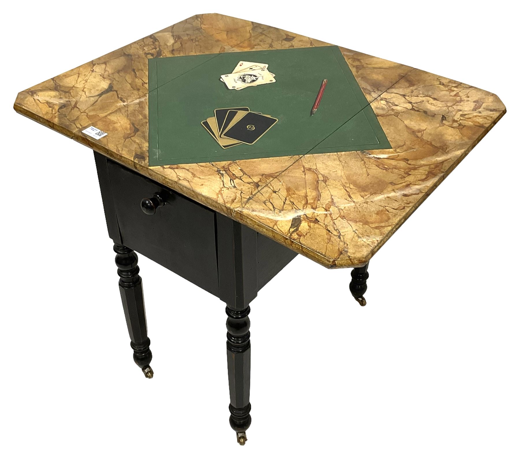 Victorian ebonised drop-leaf pot cupboard with later trompe l'oeil painted top, depicting marbled surface with baize cloth, playing cards and pencil, fitted with two drawers to one end and cupboard to the other with marble inset, on turned and faceted supports with brass castors