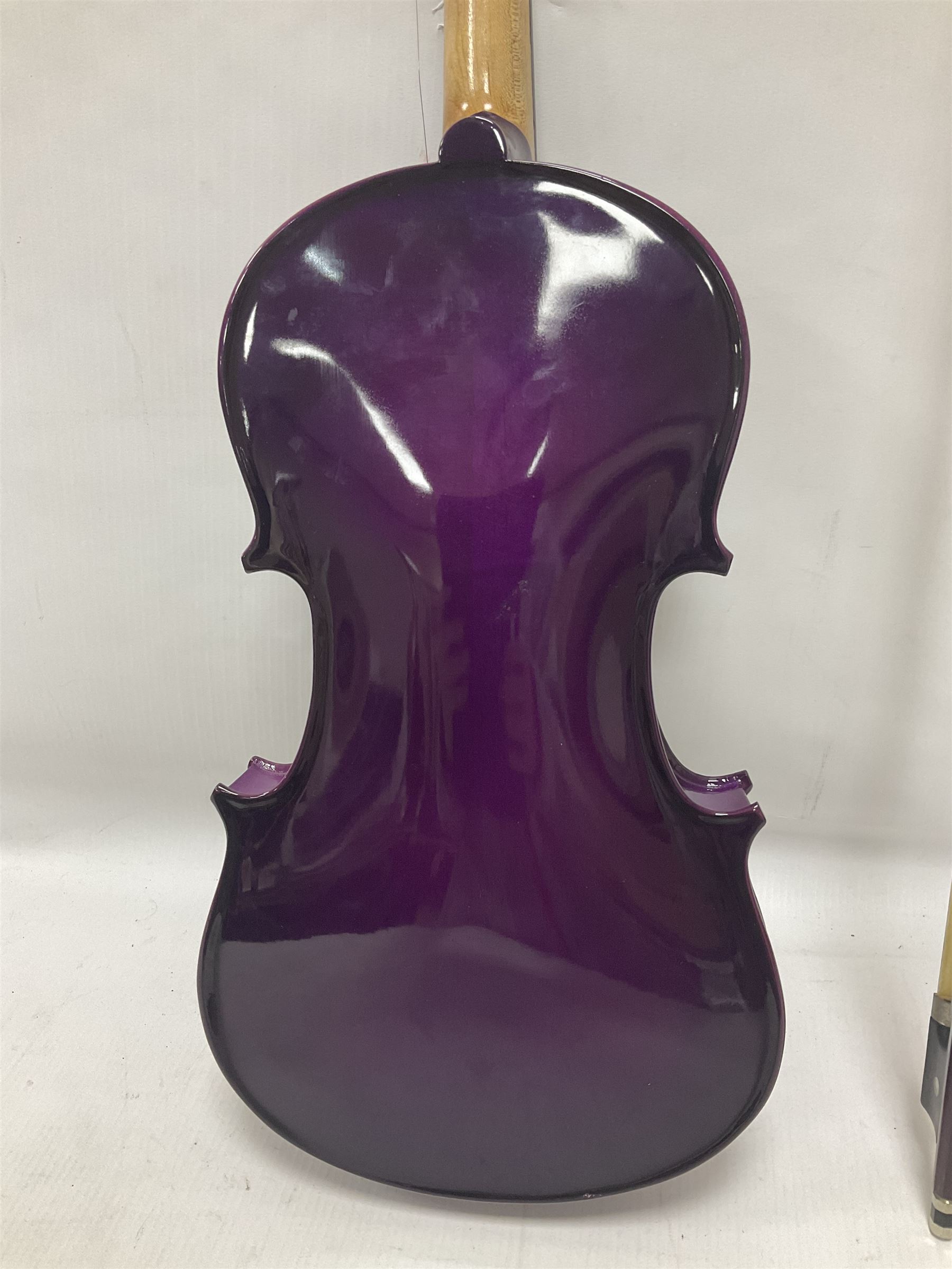 Intermusic 3/4 violin with a violet coloured solid wood body, ebonised fingerboard and fittings, bow and hard case, length 54cm