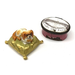 A Royal Worcester miniature model of a Spaniel dog upon a gilt cushion, c1900, with printed mark beneath, together with a Georgian enamel snuff box, detailed 'Royal Crescent A Trifle from Bath' (a/f). 