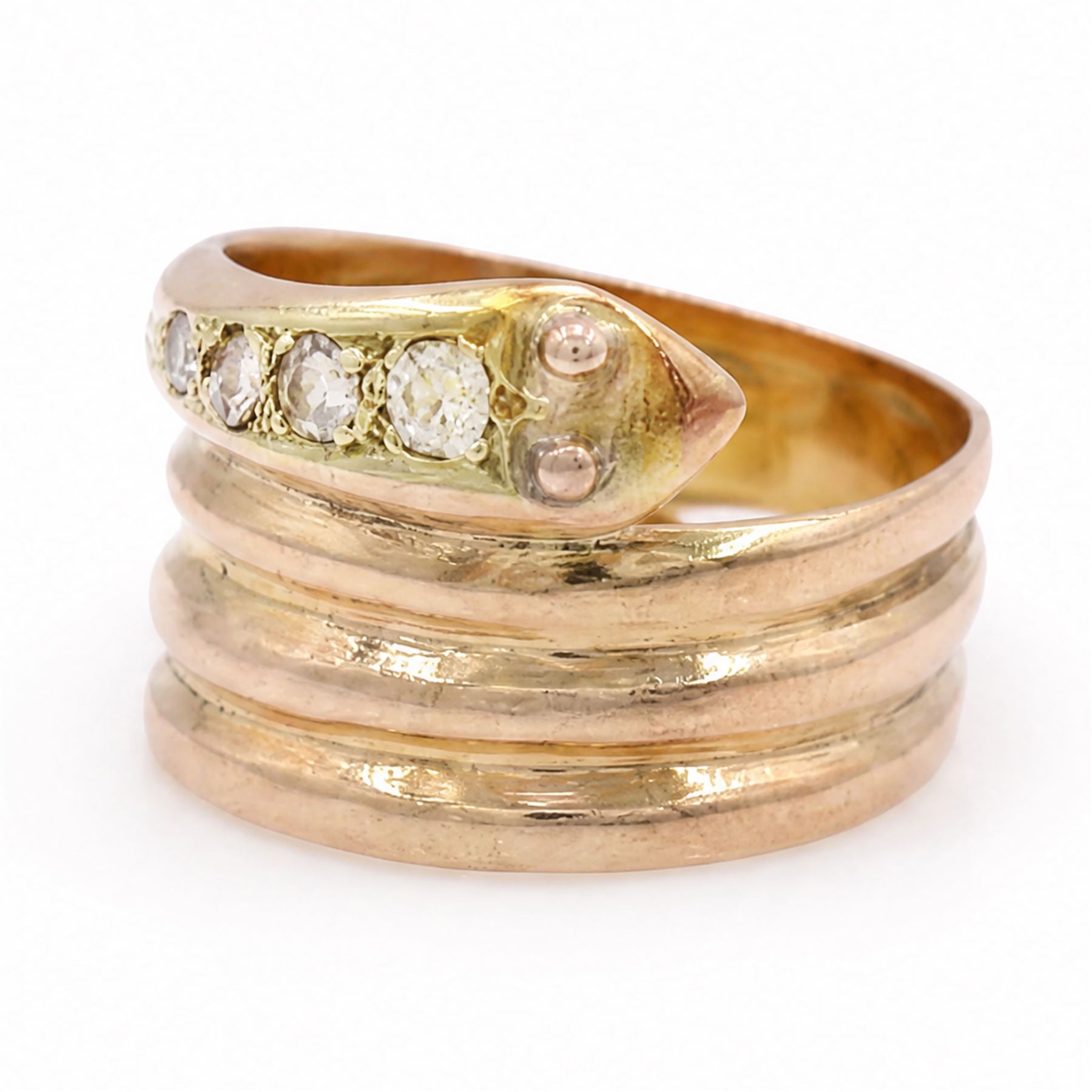 19th / early 20th century 9ct gold diamond coiled snake ring, the head set with four graduating old cut diamonds