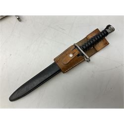 Schmidt-Rubin Model 1918 bayonet, the 30cm steel blade marked Elsener Schwyz, cross-piece numbered 813558; in steel scabbard with leather frog stamped E. Banga Sattler Selzac 67 L45.5cm overall; and Swiss Model 1957 SIG rifle bayonet by Wenger; in plastic scabbard with leather frog stamped E. Walty Sattlerei Baretswil 84 (2)