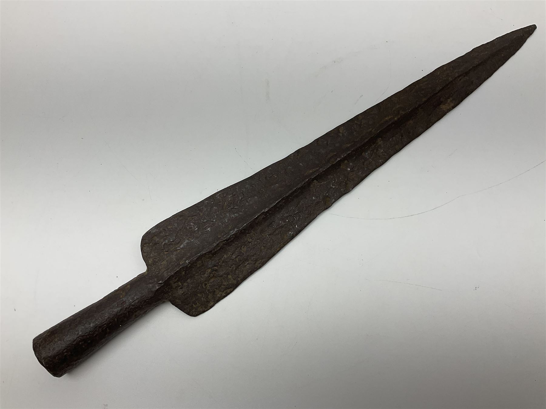 19th century continental folding knife with 15.5cm single edged blade, the pierced brass and iron handle with remains of horn grips L21.5cm overall closed; turned horn handled knife with foliate engraved blade; battlefield relic German 1884/98 knife bayonet; iron spear head; leather covered swagger stick; and two-piece gun cleaning rod