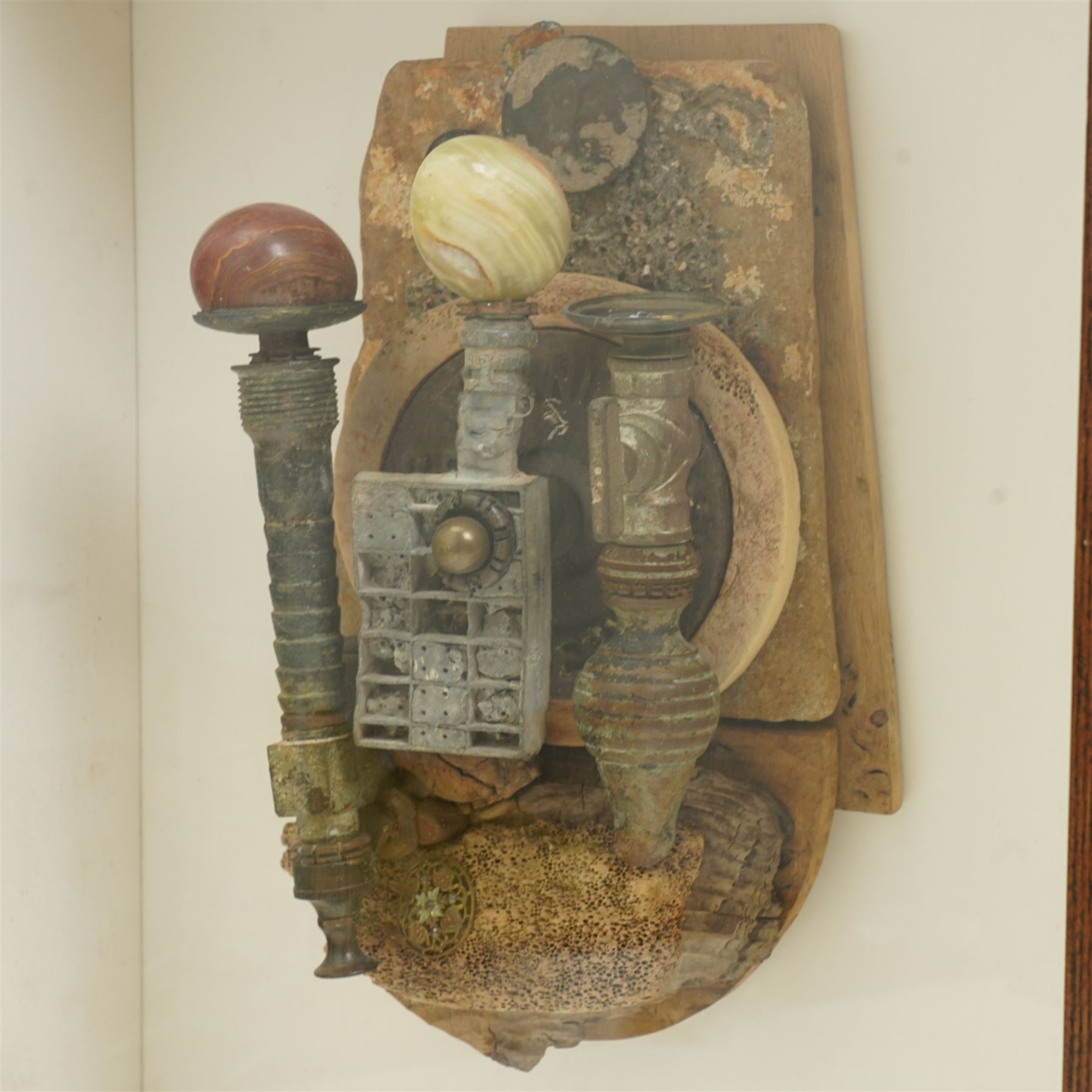 Andrew Coates (British 1939-): 'The Guardians', assemblage in wood, found objects and with three marble eggs, titled and dated 1999 verso, in case, overall 50cm x 37cm